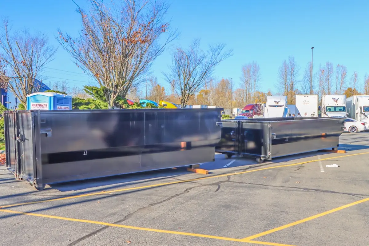 Professional dumpster rental service with roll-off container on residential driveway in Whispering Pines